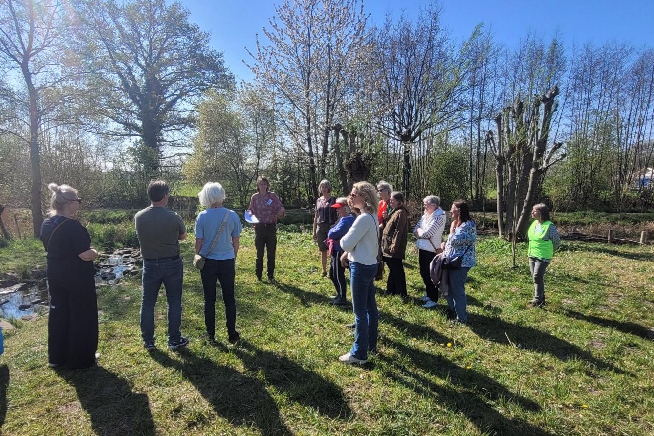 groep mensen neemt deel aan een rondleiding in de Struintuin